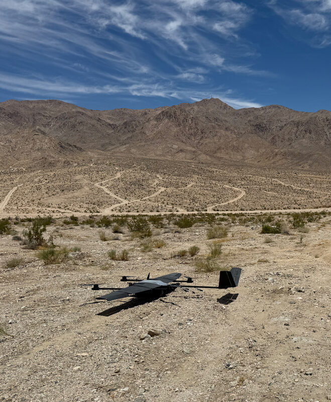 WingXpand xRAI fixed-wing drone with VTOL kit on desert ground